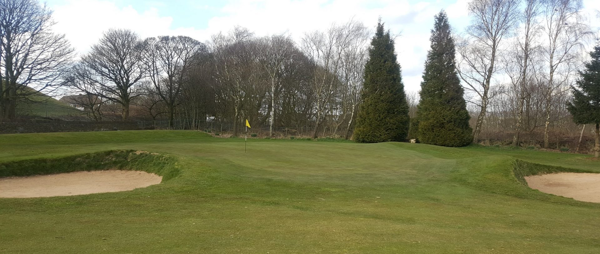 The contoured, sloping 1st Green.